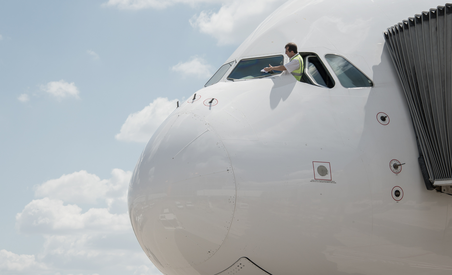 Pilot cleans his windshield at DFW Airport by commercial photographer in Dallas Kevin Brown