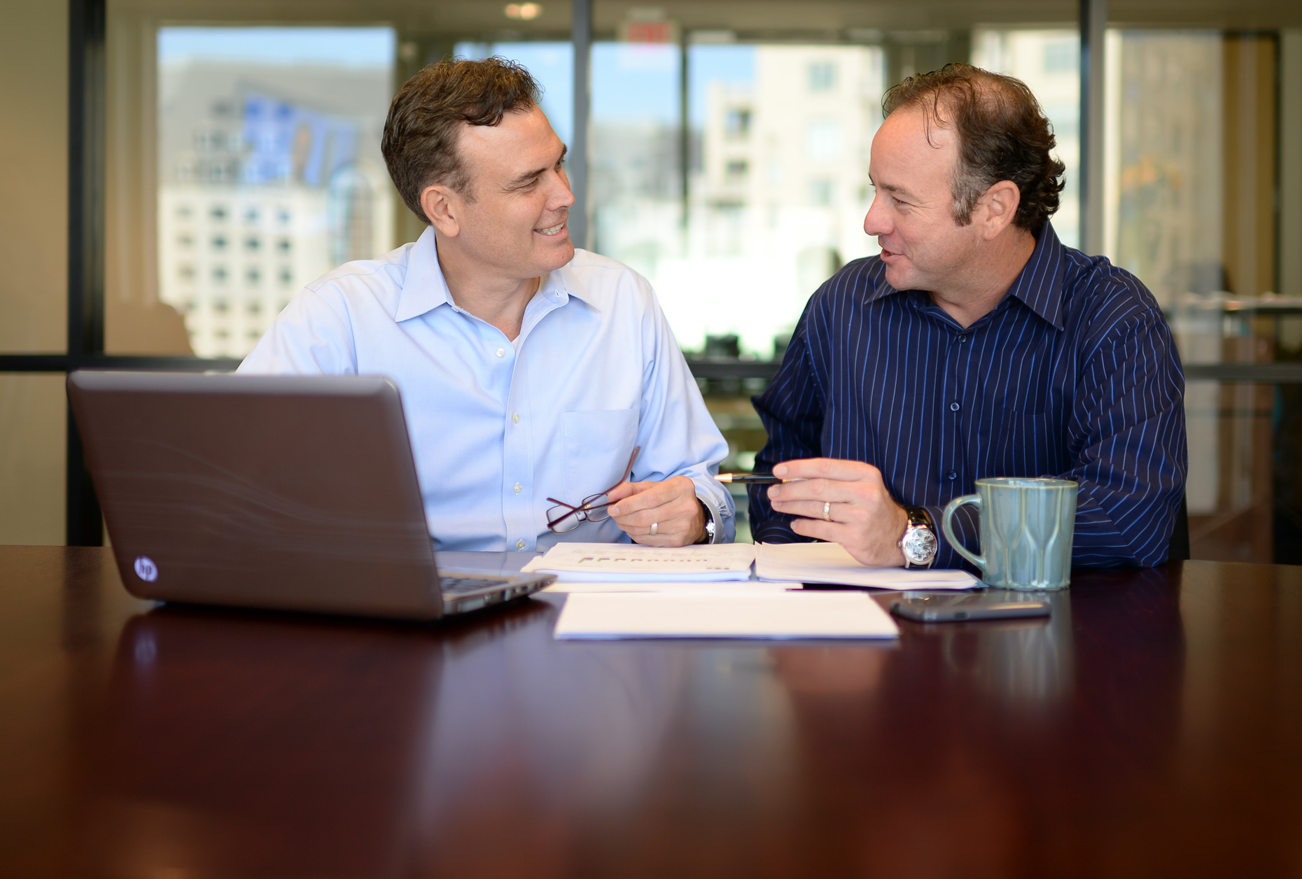 Commercial Photographer Kevin Brown photographs executives in the boardroom.