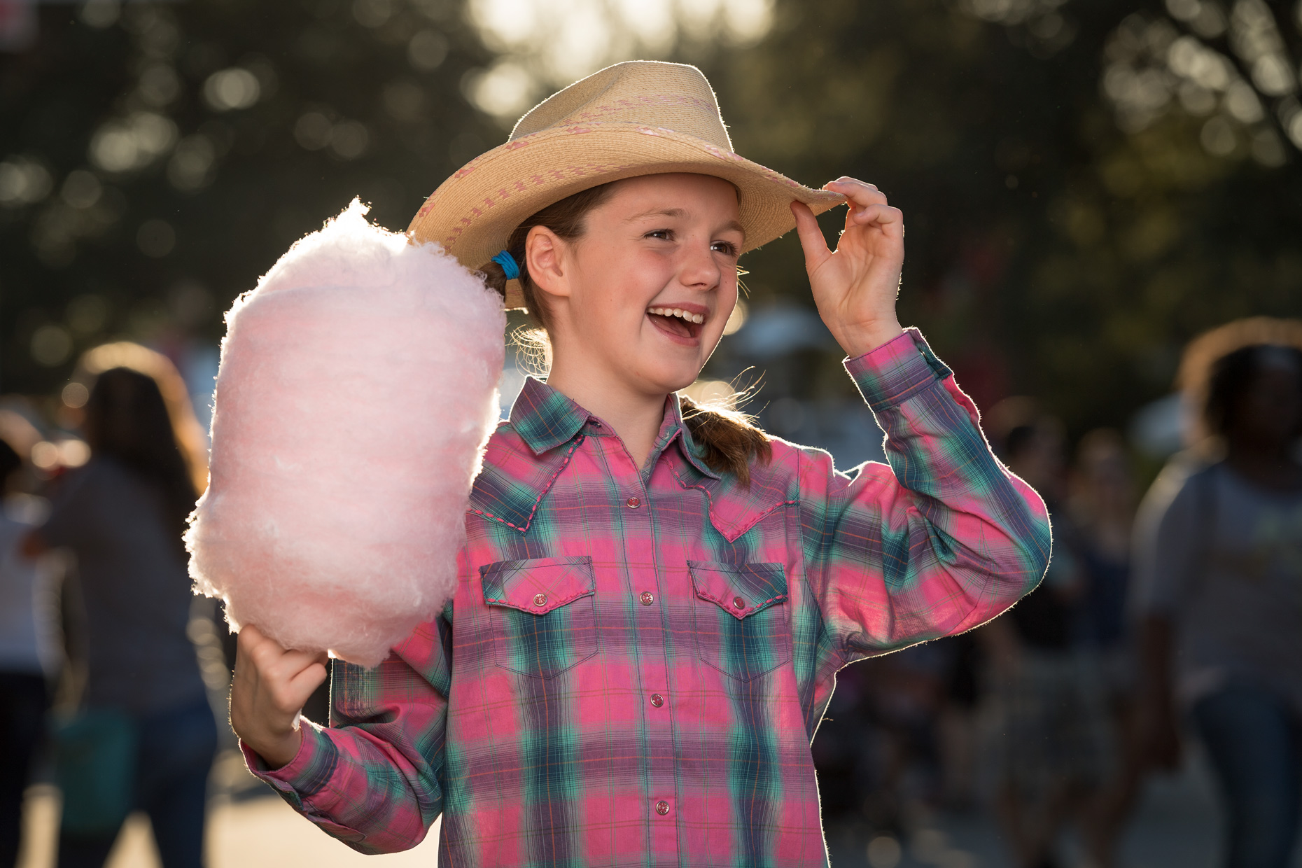 Girl with cotton candy at The State Fair of Texas. Photography by Kevin Brown