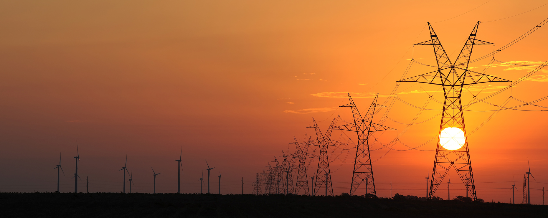 Electric transmission lines and wind turbines in west Texas by industrial photographer Kevin Brown, for Oncor.