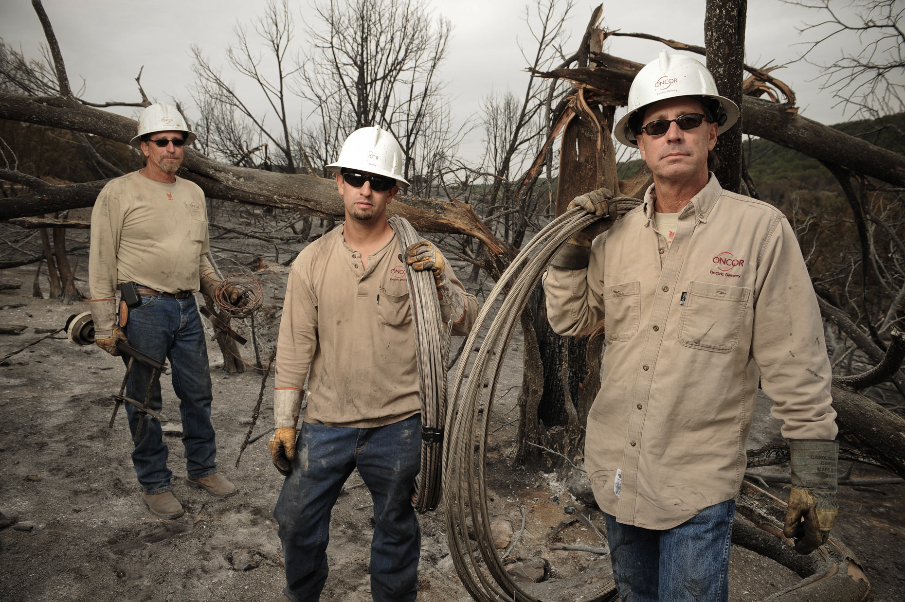 Electric workers after fires working to restore power west of Fort Worth by Kevin Brown.